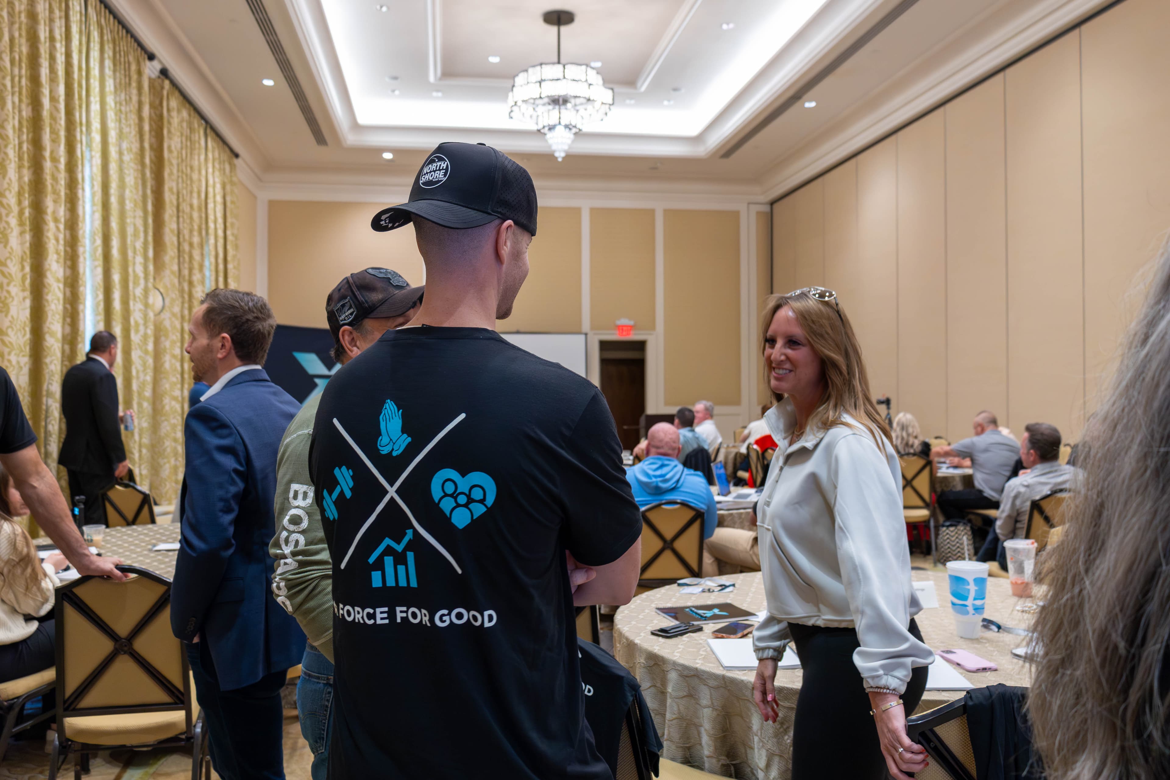 Attendee in A Force For Good t-shirt networking