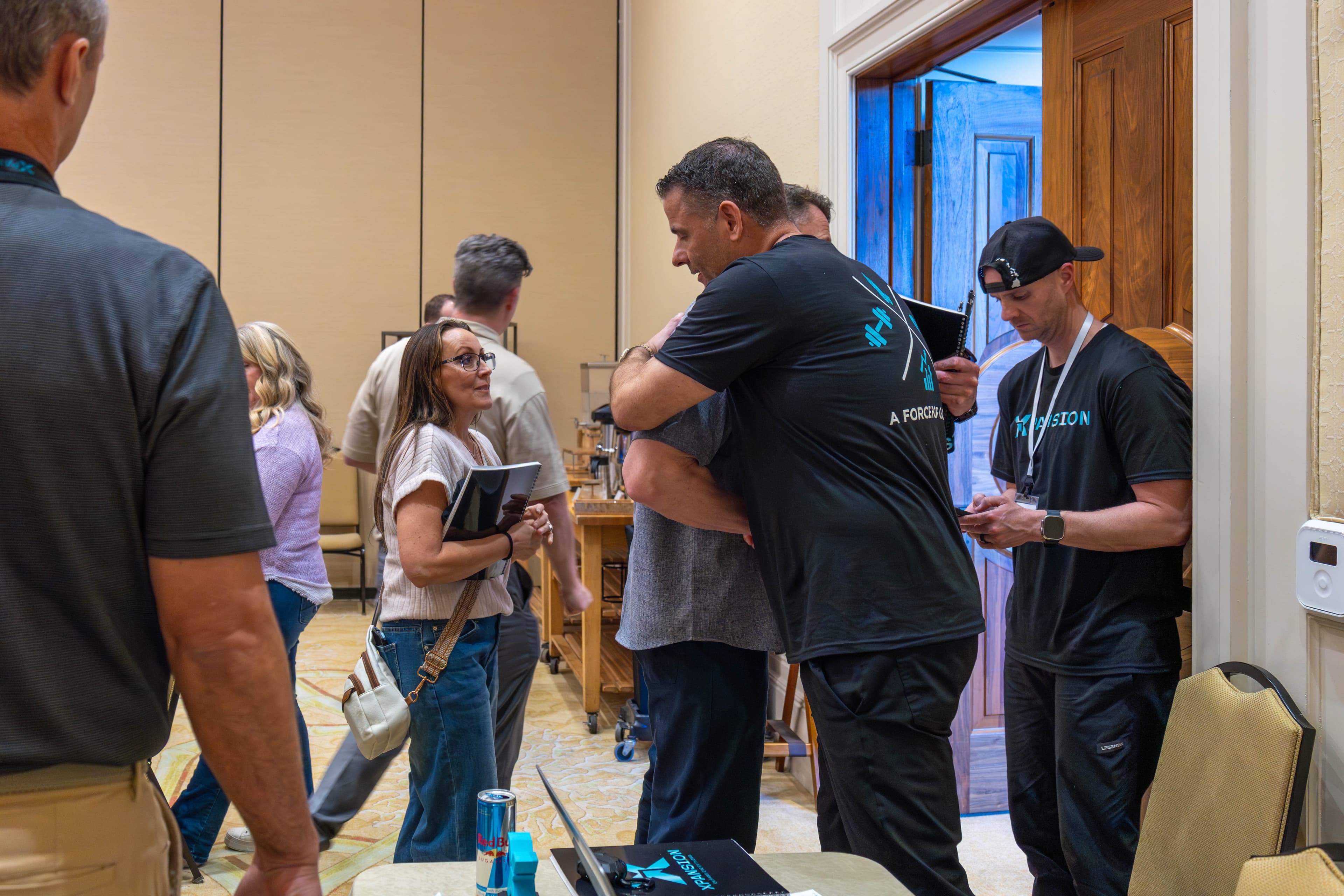 Attendees hugging during networking